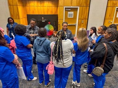 Pop Health Ambassadors address a group of high school students during Discovery Day.