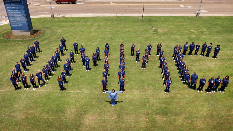 Group of nurse externs spelling out UMMC.