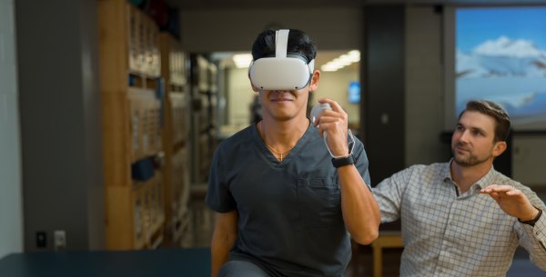 Patient uses virtual reality headset as part of physical therapy.