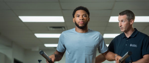 Patient focuses while doing physical therapy exercises.