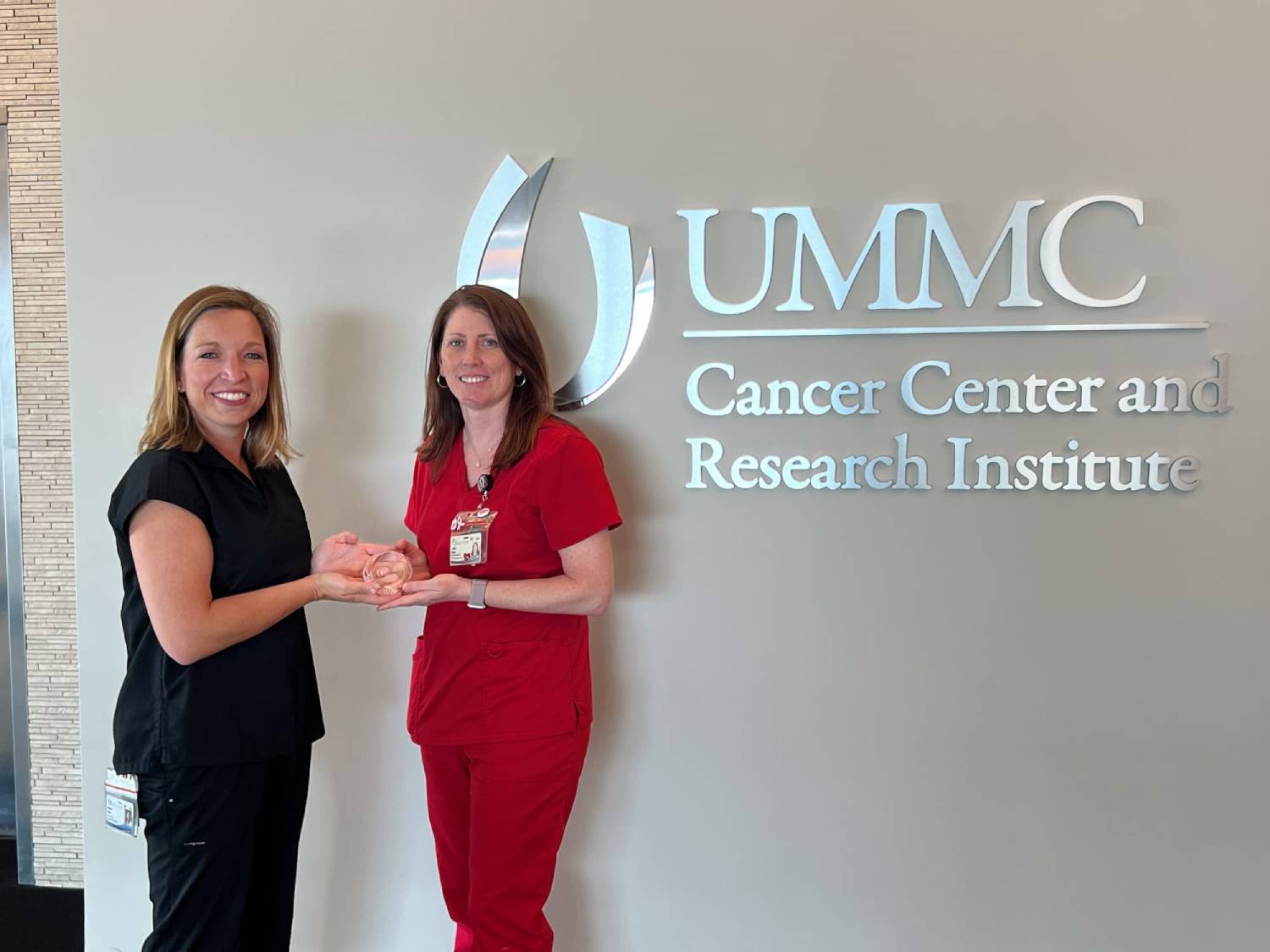 Bethany Sabins, left, congratulates Ashley Napier on being named CCRI Employee of the Month.
