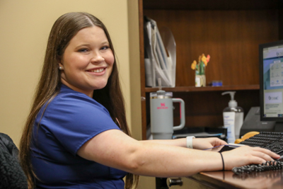 Kylie Ready checking in patients at MEWI's front desk.