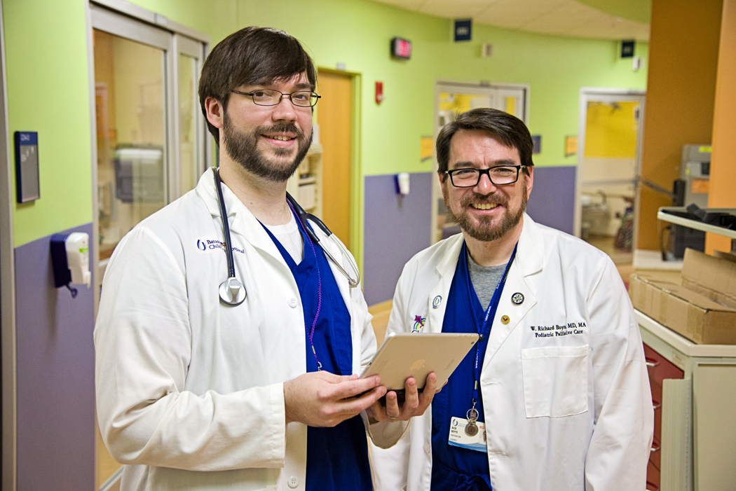 Dr. Christian Paine, left, confers with Dr. Rick Boyte, chief of pediatric palliative care.
