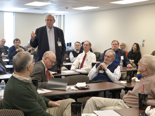 Dr. Gene Barrett, standing, one of the "Recalcitrant Residents," and brother of the group's leader, Dr. Pat Barrett, gives his take on the controversy at the March 7 reunion.