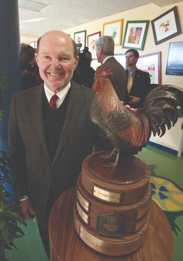 Joe F. Sanderson, Jr., CEO and board chair of Sanderson Farms, stands next to the trophy given at the annual Sanderson Farms Championship. The PGA tournament generated more than $1.1 million for Friends in 2014.