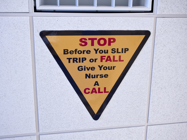 Fall prevention signs posted on the ceiling of all Adult Hospital rooms mean business: Get a nurse's help before you get out of bed.