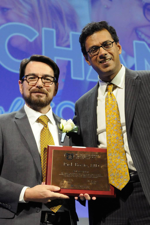 Boyte, left, is congratulated by surgeon and author Dr. Atul Gawande. Photo courtesy of Randy Goodman.