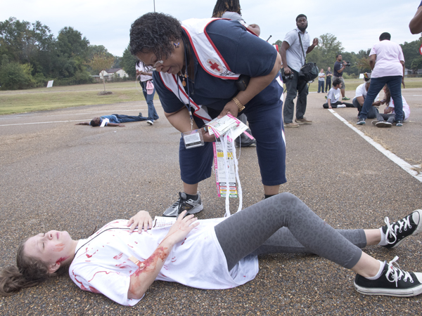 Ollie Harper, a Jackson State University nurse practitioner, assesses the "injuries" of Northwest Rankin Middle School student Whitney Robinson
