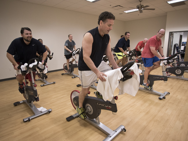 (From left) Matt Nassar, Sessions Roland and Percy Quinn take part in a spin class at the University Wellness Center in downtown Jackson.