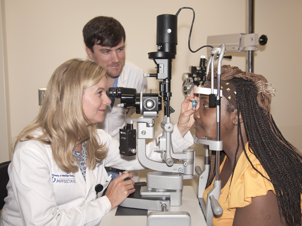 Dr. Kimberly Crowder, new chair of the Department of Ophthalmology at the University of Mississippi Medical Center, performs an eye examination on Betty Rush of Philadelphia. Assisting is Dr. Jordan Burnham, a resident in the department.