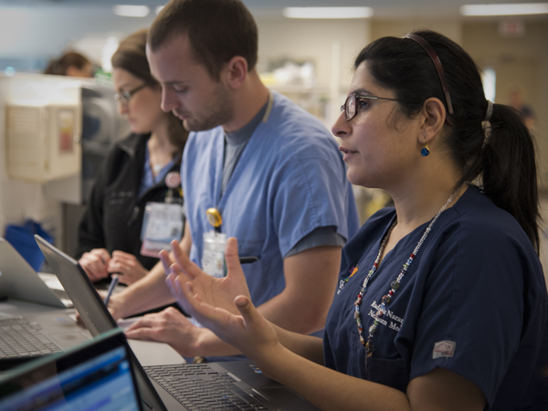 Dr. Radhika Narang, right, neonatal-perinatal fellow, rounds in the NICU with residents Dr. Edward Landry and Dr. Diana Tate.