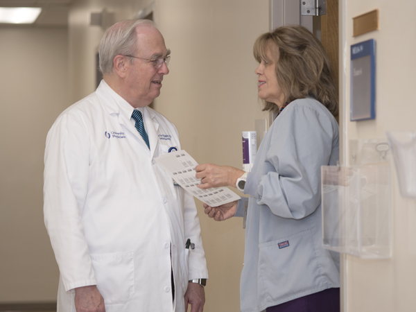 Thigpen discusses a case with Kathy Hyde, nursing supervisor in the Cancer Institute outpatient clinics at Jackson Medical Mall.