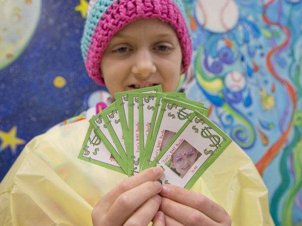 It's pay day for Toni Marino, 11, a participant in the BMT Bucks program at Batson Children's Hospital. Her BMT Bucks feature her photo on each bill.