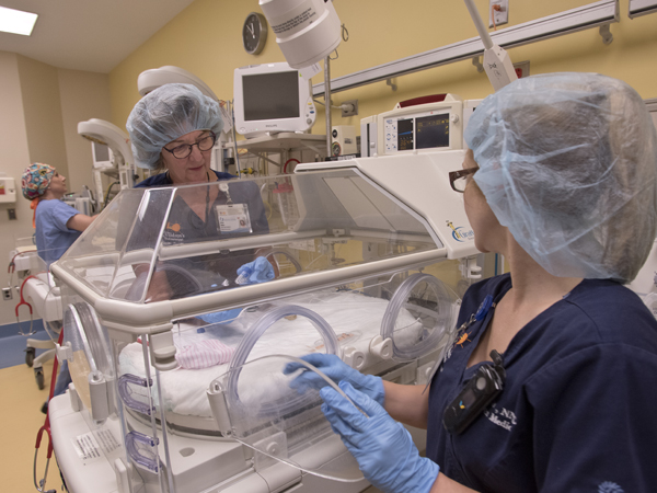 Dukes, left, and Ellis show the new neonatal resuscitation area, which includes state-of-the-art Giraffe beds and other life-saving equipment.