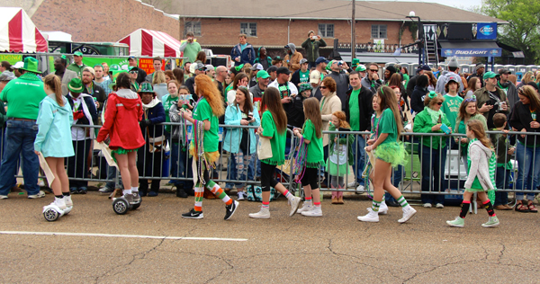 Volunteers sweep the parade route for donations.