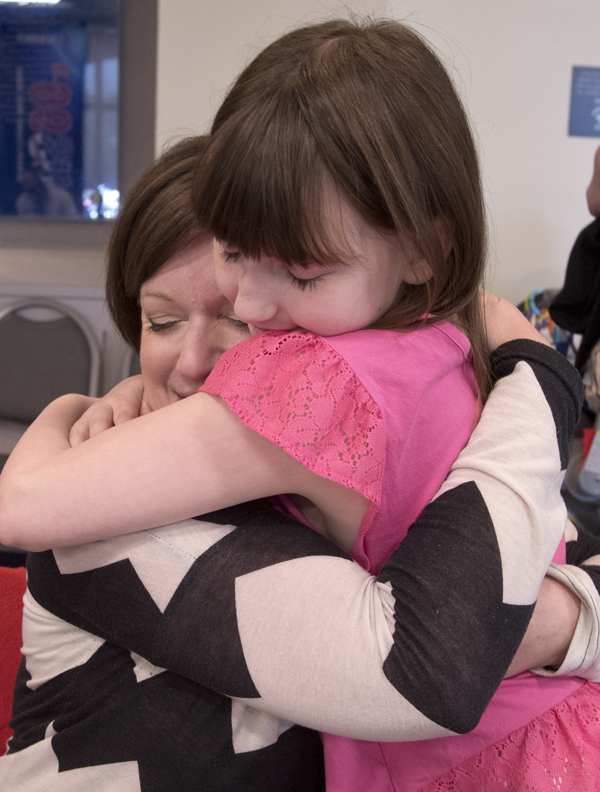 Caylen Ayscue hugs Evelyn Johnson, an on-air personality for River 101.3, during the Mississippi Miracles Radiothon.