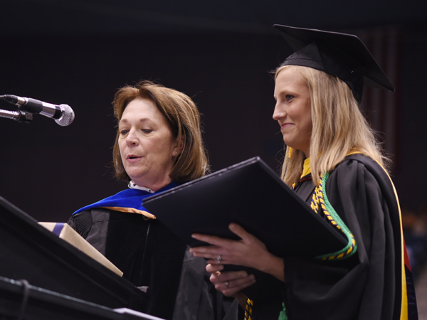 Dr. Jessica Bailey, dean of the School of Health Related Professions, presents the Dr. Virginia Stansel Tolbert Award to Brenna Shoemaker of Flowood.