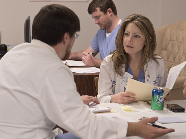 Dr. Chasity Torrence, right, and fourth-year medical student Jonathan Baker review a case on October 15 at the Jackson Free Clinic.