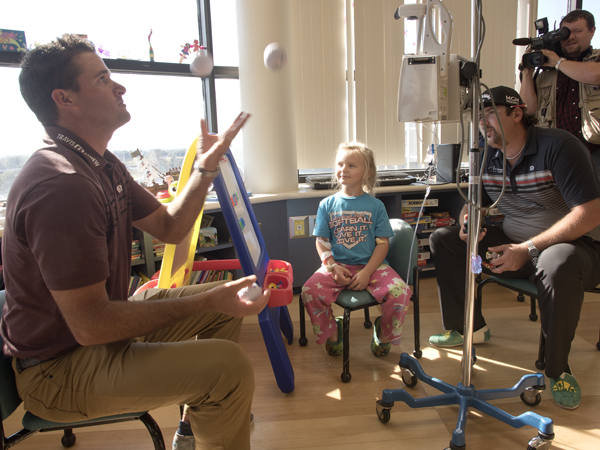 PGA golfer Sam Saunders took up juggling during a visit to Batson Children's Hospital. Looking on are, from left, patient Kimber Norris of Moselle, PGA golfer Andres Gonzales and Drew Hall of WJTV.