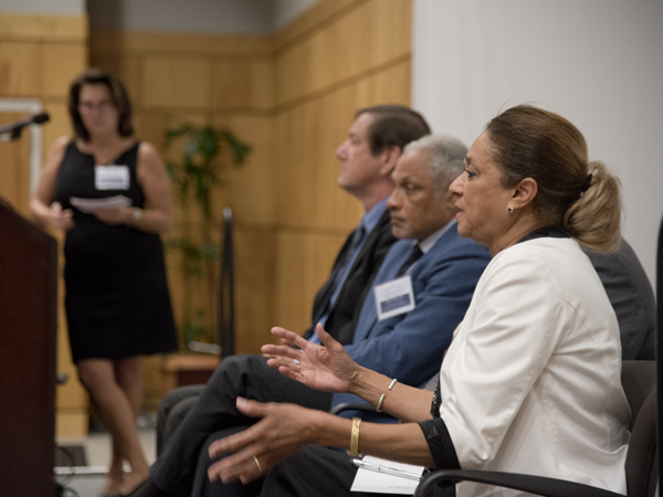 Oleta Fitzgerald, right, makes a point during a panel discussion moderated by Dr. Leslie Hossfeld, far left, at podium. Other panelists pictured are, from left, Dr. Gregory Bohach and Mike Espy. Not visible is panelist Dr. Dolphus Weary.