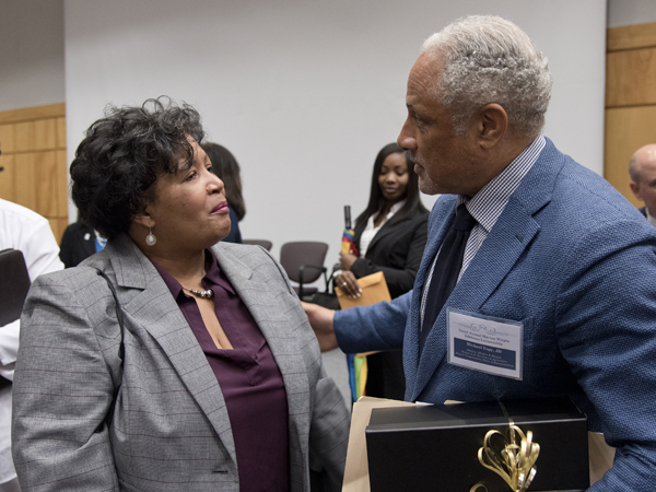 Reena Evers-Everette, left, executive director of the Medgar and Myrlie Evers Institute, has a word with Espy following his presentation.