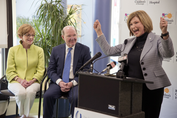 Dr. LouAnn Woodward, UMMC vice chancellor for health affairs and dean of the School of Medicine, cheers at the announcement of a $10 million gift to Children's of Mississippi by Joe and Kathy Sanderson, looking on.
