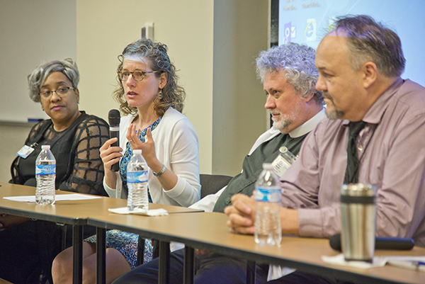 Doris Whitaker, left, director of pastoral services; Rabbi Debra Kassoff, second from left, of Beth Israel Congregation; Murphy, second from right; and Darrell Troth, a Jackson Medical Mall Foundation employee, discuss religion's role in the workplace.