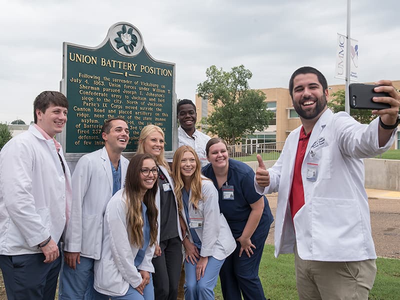 It's selfie time for Justin Cabral and his School of Pharmacy  classmates, from left, Cain Young, Chad Bowman, Kristen Garcia, Ashton Smith, Alley Harper, Martin Love and Megan Harlow on their self-guided campus tour.