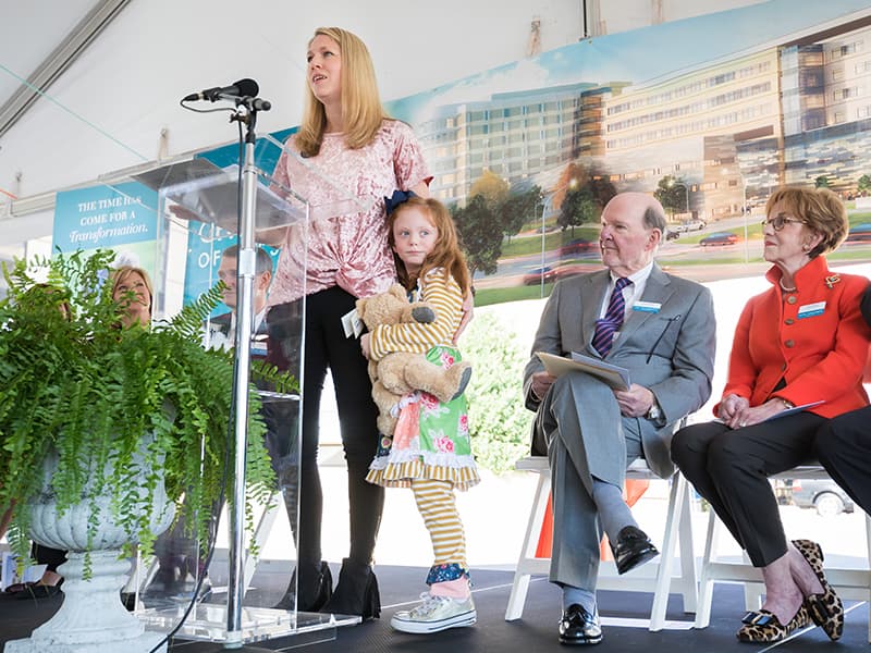 Megan Bell of Pearl tells her daughter Avery's story during the groundbreaking for a new children's tower.