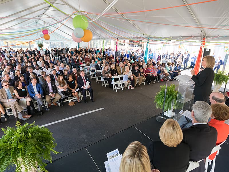 Hundreds of state leaders, philanthropists, medical professionals, patients and their families listen as Dr. LouAnn Woodward, vice chancellor for health affairs and dean of the School of Medicine, speaks during the groundbreaking ceremony Friday.