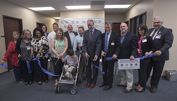 Pediatricians, health care professionals and city of Biloxi leaders join Lauren Bradshaw and son Andrew Fillingame in cutting the ribbon at the new Children's of Mississippi specialty clinic in Biloxi. Andrew, center, is a patient of neurologist Dr. Mark Lee at the clinic.