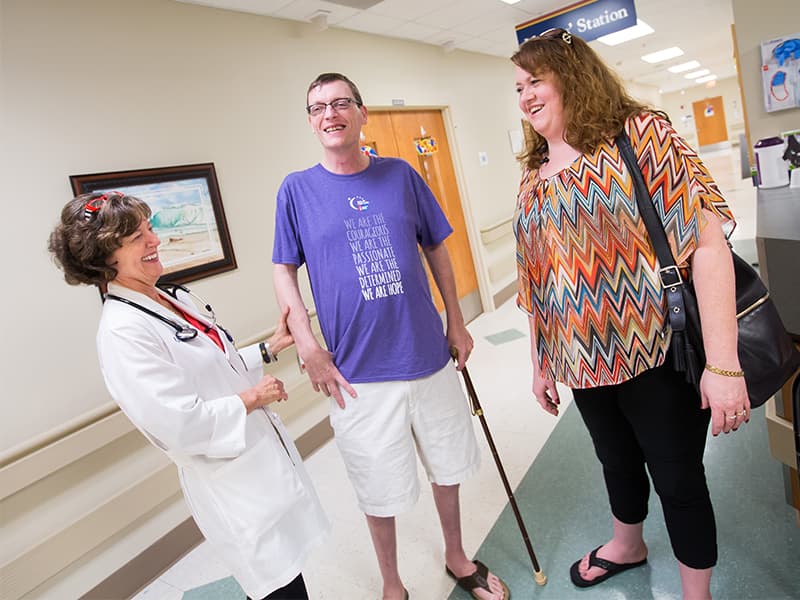 Dr. Carolyn Bigelow, left, greets Caleb and Melissa Rich during a follow-up visit for Caleb at the UMMC Bone Marrow Transplant Unit. Caleb had a stem cell transplant in 2013.