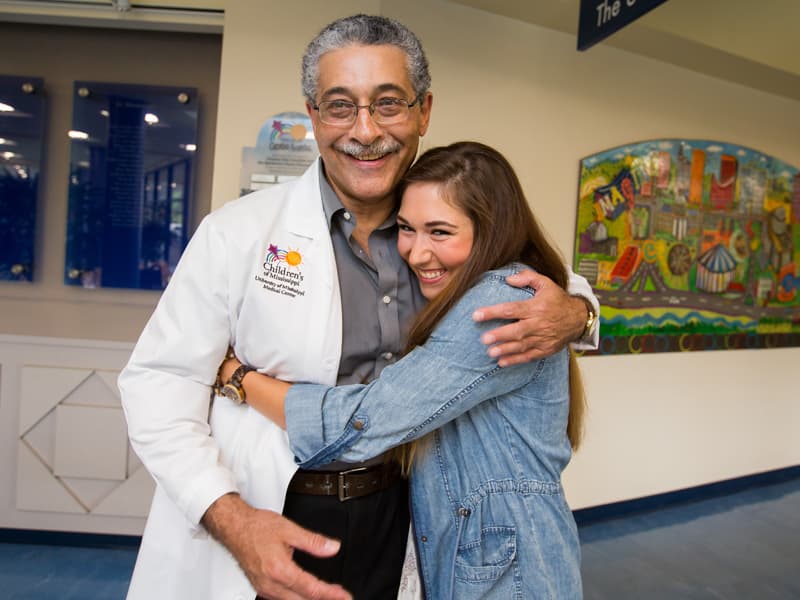 Hayleigh Craft, right, reminisces with her pediatric cardiologist, Dr. Makram Ebeid. As an adult, she sees Dr. William Campbell.