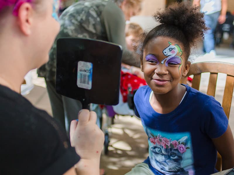 Shyenna Johnson of Greenville, a Batson Children's Hospital patient, shows her unicorn face paint during Mississippi Children's Museum Day at the hospital.