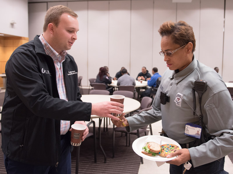 Logan Ramsey, ASB chief of staff, offers a beverage to Eureka Robinson, UMMC police officer, during Tuesday's appreciation lunch.