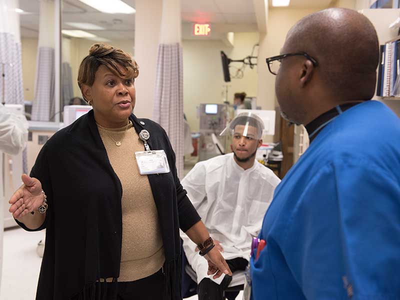Alice Luckett, UMMC clinical director of dialysis, discusses where to locate an influx of patients with Jessie Austin, a dialysis biomedical engineering technician.