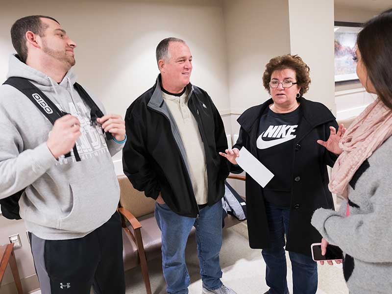 Sands, left, visits with his parents, David and Nanci Sands, and girlfriend, Mary Grace Eppes, before his recent cancer surgery at UMMC. 