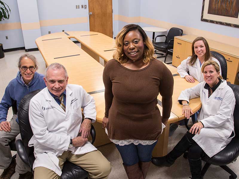 Tomeka Harps, center, visits with members of the medical team that helped save her life, from left, Dr. Stephen Raab, Dr. Kim Geisinger, Dr. Mildred Ridgway and Bethany Sabins.