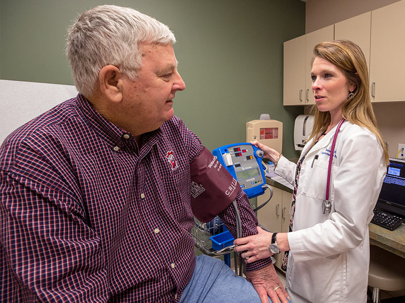 Theresa Hutson, clinical research coordinator, takes a blood pressure measurement for Billy Pittman of Florence. Pittman visited the clinics to learn about a heart failure study, one of many ways UMMC is researching cardiovascular disease.