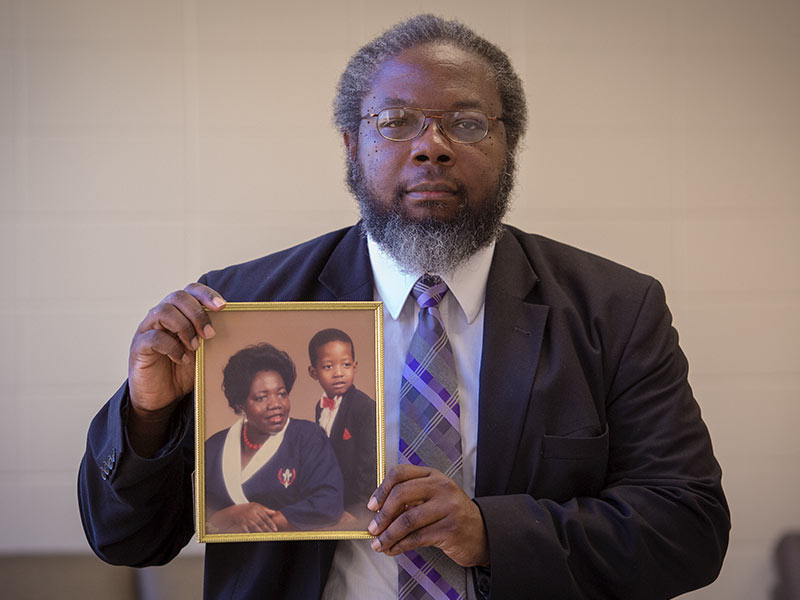 Dr. Stanley Smith holds a photo of his sister, Dorothy Ann Johnson, and her son, Shannon, close to his heart.