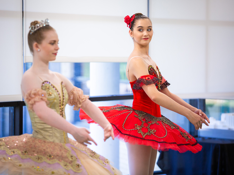 From left, Mississippi Metropolitan Ballet dancers Taylor Binkley and Mattie Grace Morris demonstrate the second position in a ballet learning lab.