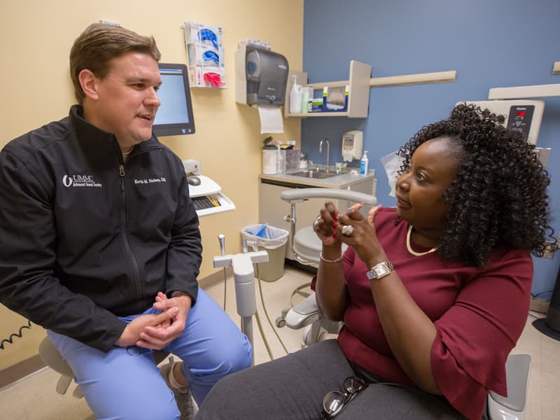 Jennifer Johnson talks with Dr. Kevin Nelson during a recent checkup at UMMC's Oral Oncology Clinic.
