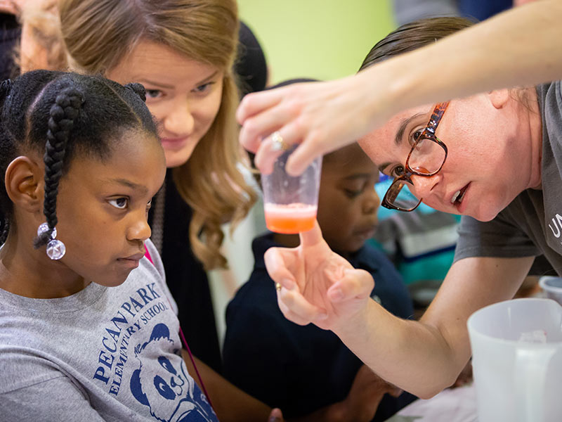 First-year Ph.D. student Ciara McKnight shows NAME how DNA extraction works.