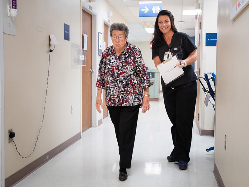 Peggy Dudley performs a walking test for Kristy Womack, structural heart coordinator in the Adult Heart Valve Program.