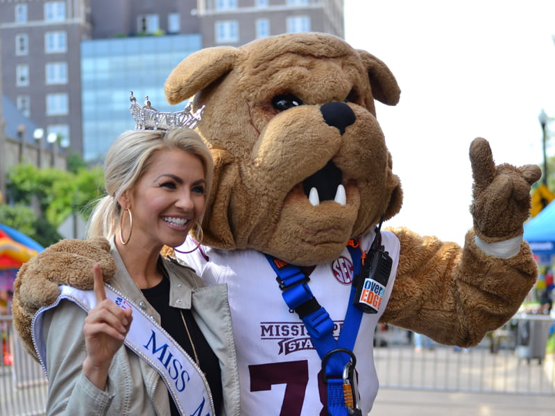 Miss Mississippi Anne Elizabeth Buys smiles with Mississippi State University mascot Bully. who was among those rappelling in Over The Edge for Friends of Children's Hospital.