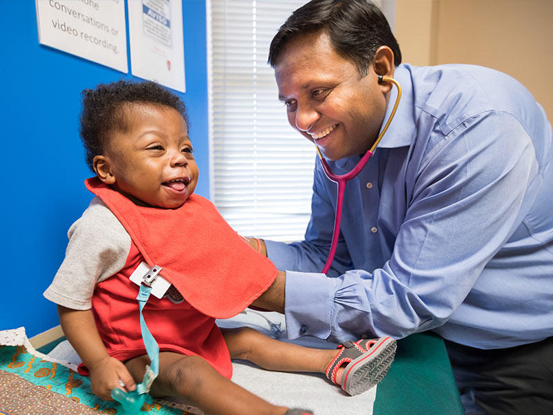 Jharad Faust laughs during a check-up with his pediatric cardiologist, Dr. Avichal Aggarwal.