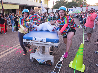 Nurses representing Telehealth including Kourtland Adams, Megan Duet and Terri Morgan take part in a gurney race to celebrate 2016 National Nurses Week. 