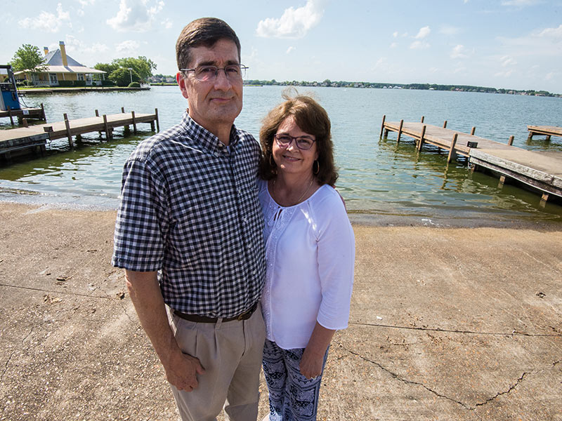 Madison residents Dan and Ann Smith stand at the dock on Lake Caroline where Dan in April 2017 suffered catastrophic injuries in a boating accident.