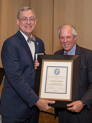 Hall of Fame selectee Dr. Robert Robbins, right, receives his award from Dr. Tim Folse, outgoing president of the Medical Alumni Chapter.
