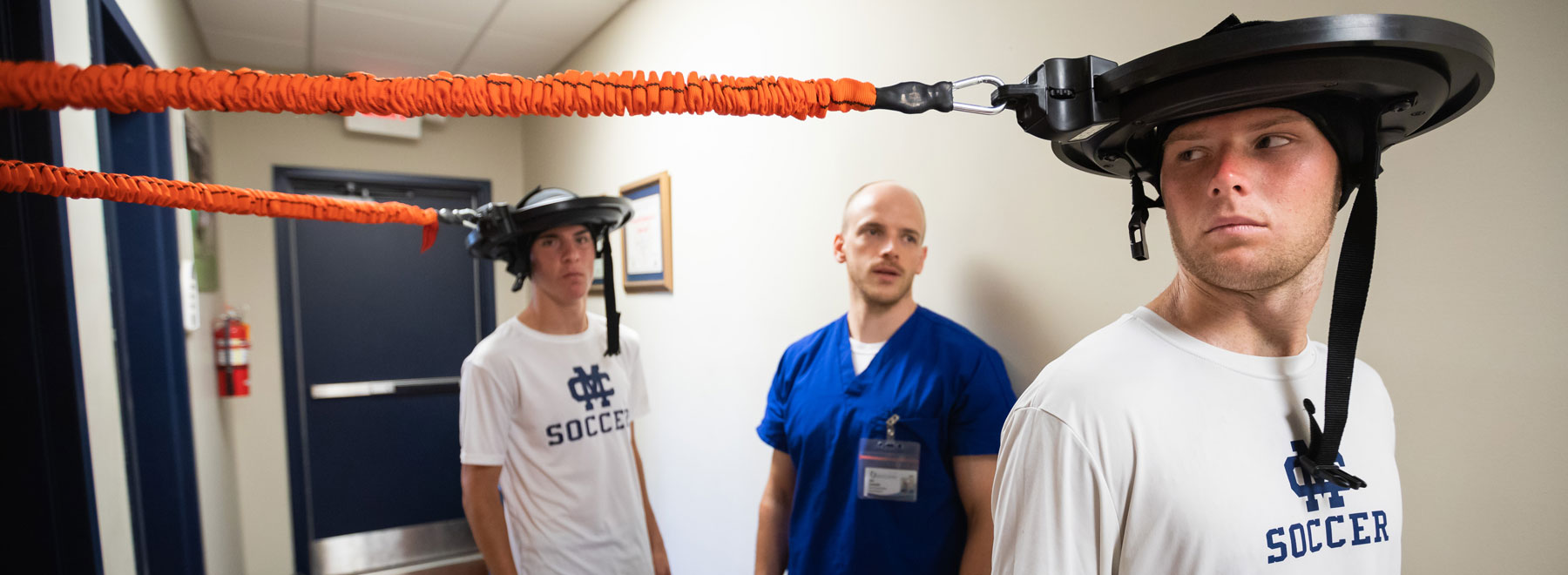 Physical therapy resident Tyler Luchtefeld, center, monitors motor skills and movement testing on soccer players Carlos Hernandez-Vicente, left, and Connor Johnson.